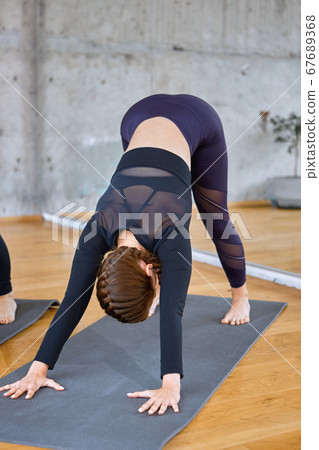 Unrecognizable woman practicing in hall. Unrecognizable woman practicing in hall. 67689368