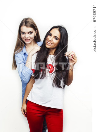 best friends teenage girls together having fun, posing emotional on white background, besties happy smiling, lifestyle people concept, blond and brunette multi nations 67689714