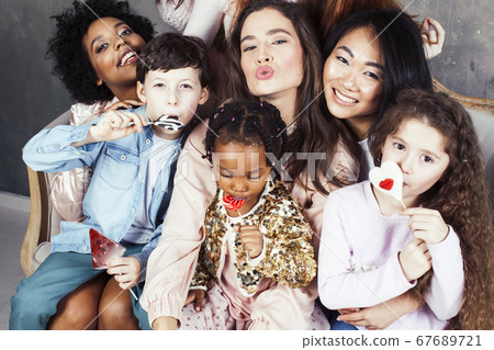 Lifestyle and people concept: young pretty diversity nations woman with different age children celebrating on birth day party together happy smiling, making selfie. African-american, asian and 67689721
