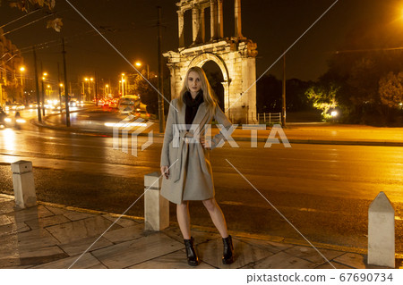 Beautiful Young Woman In A City At Night 67690734