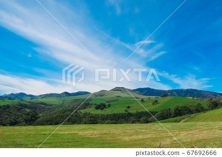 It is a vast landscape of the Naitai Kogen Ranch where you can see the grazing cows in Kamishihoro, Hokkaido. It is a vast landscape of the Naitai Kogen Ranch where you can see the grazing cows in Kamishihoro, Hokkaido. 67692666