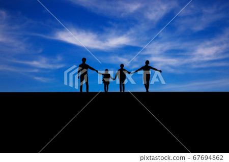 Happy family photo taken against a blue sky 67694862