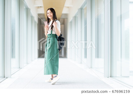 Girl walking in college corridor 67696159