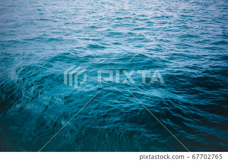 Blue sea surface, top view. Dark mood tone. 67702765