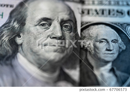 One hundred dollars and one dollar bills. Closeup of Benjamin Franklin and George Washington . US dollars background. American currency. 67706573