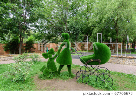 Flower sculpture of green grass of woman with a 67706673