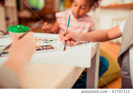 Children painting with the brush and watercolors Children painting with the brush and watercolors 67707112