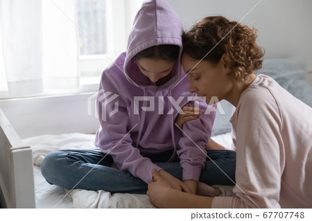 Caring mother hugging, comforting depressed upset teenage daughter Caring mother hugging, comforting depressed upset teenage daughter 67707748
