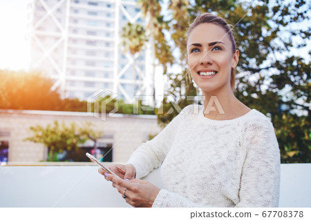 Smiling female lawyer is talking on mobile phone about her winning trial 67708378