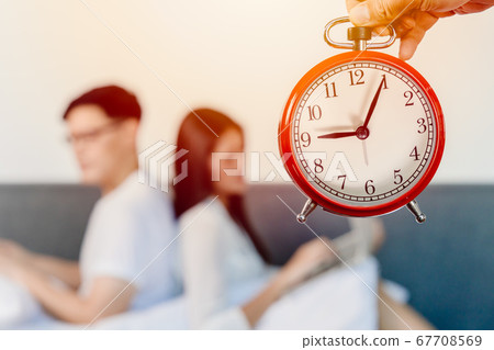 Alarm clock with blur people sitting facing back for bad relationship times of living together Alarm clock with blur people sitting facing back for bad relationship times of living together 67708569