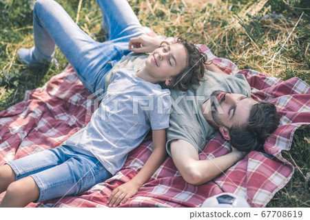 Dad and son resting ang looking relaxed 67708619