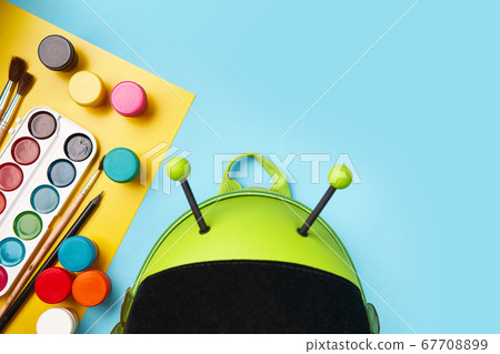 top view of green backpack with school stationery. preschool back to school top view of green backpack with school stationery. preschool back to school 67708899