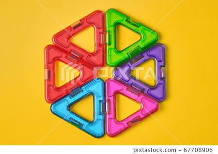 Top view of colorful magnetic building blocks on yellow background Top view of colorful magnetic building blocks on yellow background 67708906