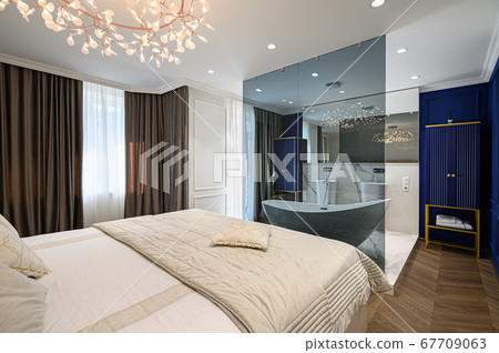 Big comfortable double bed in elegant classic bedroom Big comfortable double bed in elegant classic bedroom 67709063