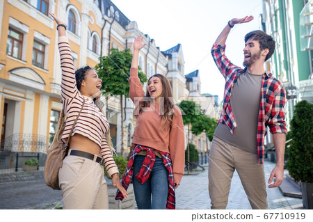 Three young friends having fun in the city. 67710919