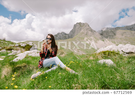 woman traveller using smartphone in mountains 67712569