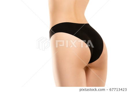 Beautiful female legs, buttlocks and belly isolated on white background. Sportive, sensual body with well-kept skin in underwear. Beautiful female legs, buttlocks and belly isolated on white background. Sportive, sensual body with well-kept skin in underwear. 67713423