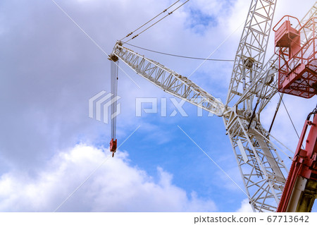 Crawler crane against blue sky and white clouds. Crawler crane against blue sky and white clouds. 67713642