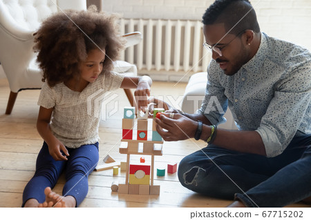 Loving biracial dad play blocks with little daughter Loving biracial dad play blocks with little daughter 67715202