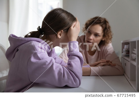 Strict angry mother scolding teenage daughter for bad exam results Strict angry mother scolding teenage daughter for bad exam results 67715495
