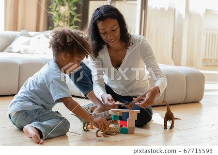 Playful biracial mom play at home with little son Playful biracial mom play at home with little son 67715593
