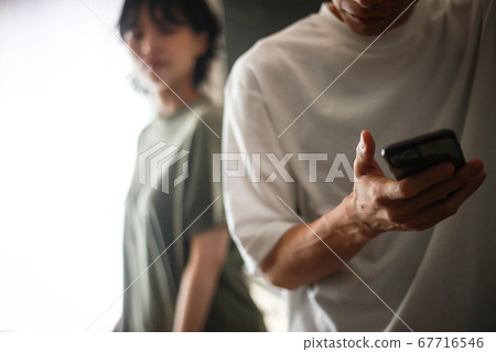 A man who takes out a smartphone 67716546