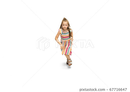 Happy little caucasian girl jumping and running isolated on white background Happy little caucasian girl jumping and running isolated on white background 67716647