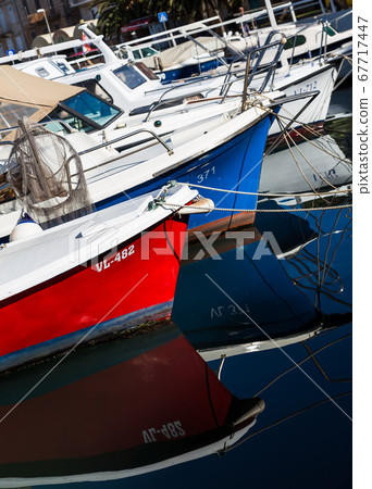 Boats reflecting in the water Boats reflecting in the water 67717447