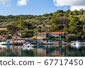 Green trees and shrubs behind Vela Luka harbour 67717450