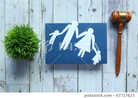 The concept of family law. Family with children cutout and gavel on table. 67717625