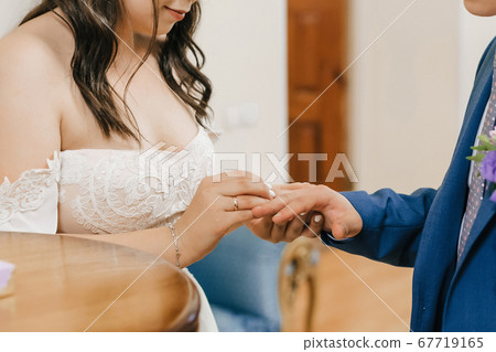 wedding ceremony of exchange of rings between the bride and groom 67719165