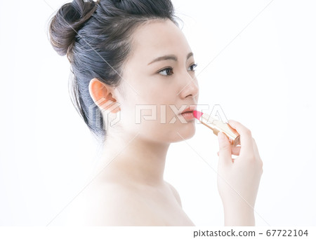 Young lady painting lipstick Young lady painting lipstick 67722104