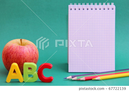 English ABC alphabet letters next to apple. 67722139