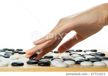 close up of player hand with weiqi stone close up of player hand with weiqi stone 67722821