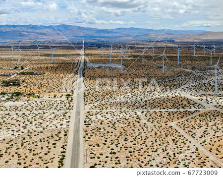 Aerial view of huge array of gigantic wind turbines spreading over the desert in Palm Springs. 67723009