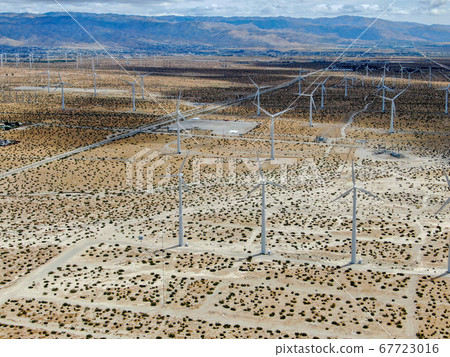 Aerial view of huge array of gigantic wind turbines spreading over the desert in Palm Springs. 67723016