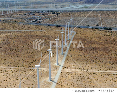 Aerial view of huge array of gigantic wind turbines spreading over the desert in Palm Springs. 67723152