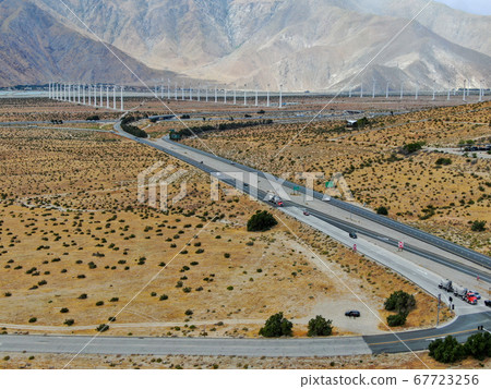 Aerial view of huge array of gigantic wind turbines spreading over the desert in Palm Springs. 67723256