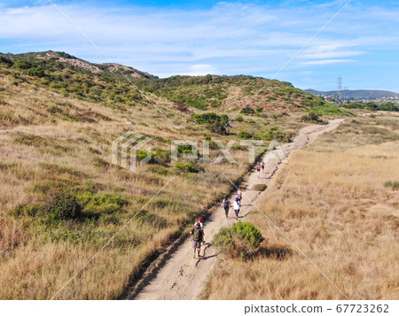 Aerial view of Los Penasquitos Canyon Preserve with tourists and hikers on the trails, San Diego 67723262