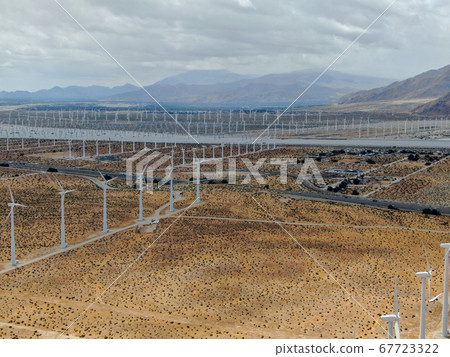 Aerial view of huge array of gigantic wind turbines spreading over the desert in Palm Springs. 67723322