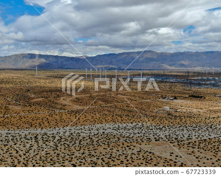 Aerial view of huge array of gigantic wind turbines spreading over the desert in Palm Springs. 67723339