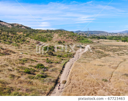 Aerial view of Los Penasquitos Canyon Preserve with tourists and hikers on the trails, San Diego Aerial view of Los Penasquitos Canyon Preserve with tourists and hikers on the trails, San Diego 67723463