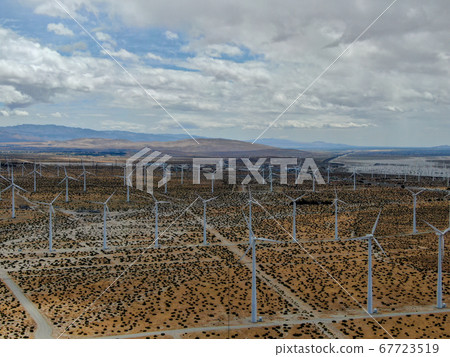 Aerial view of huge array of gigantic wind turbines spreading over the desert in Palm Springs. 67723519