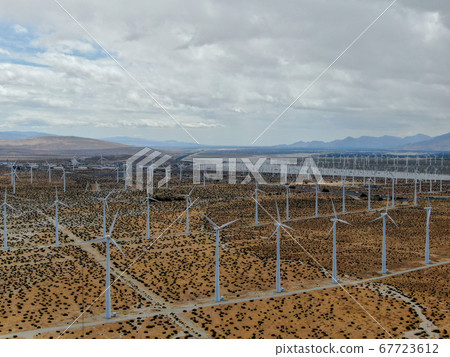 Aerial view of huge array of gigantic wind turbines spreading over the desert in Palm Springs. 67723612