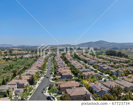 Aerial view of upper middle class neighborhood with residential houses in green valley Aerial view of upper middle class neighborhood with residential houses in green valley 67723734
