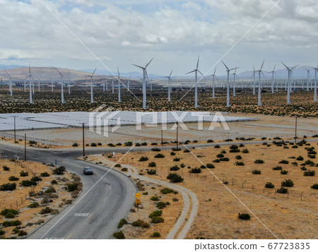 Aerial view of huge array of gigantic wind turbines spreading over the desert in Palm Springs. 67723835