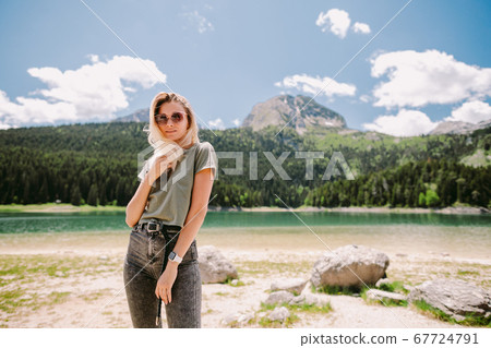 attractive woman travel in mountains with lake view and forest attractive woman travel in mountains with lake view and forest 67724791