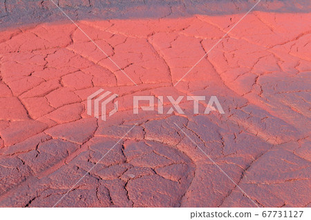 Texture of red wet ground polluted with iron ore Texture of red wet ground polluted with iron ore 67731127