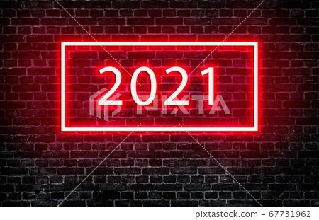 Text wording 2021 with neon lighting effect on black brick wall. Text wording 2021 with neon lighting effect on black brick wall. 67731962