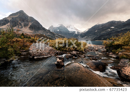 Mount Assiniboine with water flowing in golden 67735423